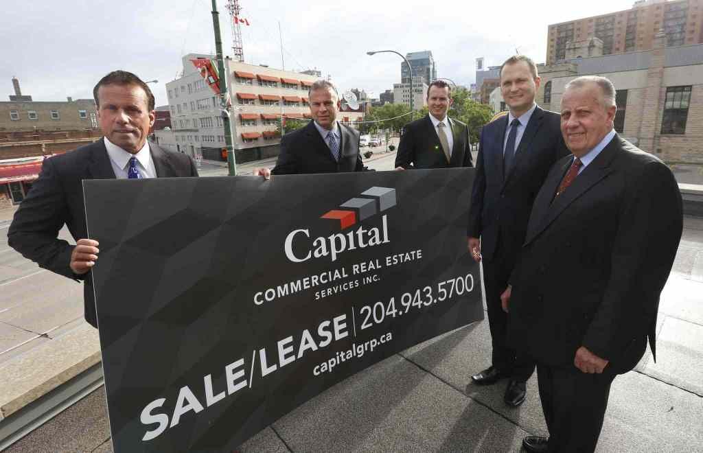 From left, Carey Chartier, Principal, Derrick Chartier, Principal, Trevor Clay, Principal, Rennie Zegalski, Principal and Marcel Chartier, Broker with a Capital Commercial Real Estate Services sign. The local office of real estate firm CBRE on Portage Ave is rebranding to Capital Commercial Real Estate Services.¤Geoff Kirbyson story. Wayne Glowacki / Winnipeg Free Press July 24 2015
